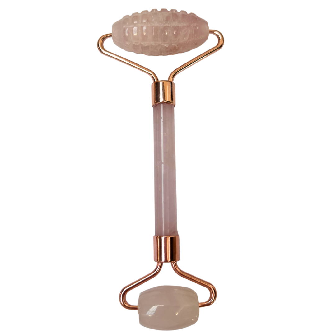 A rose quartz face roller with a handle, used for skin care and massage.